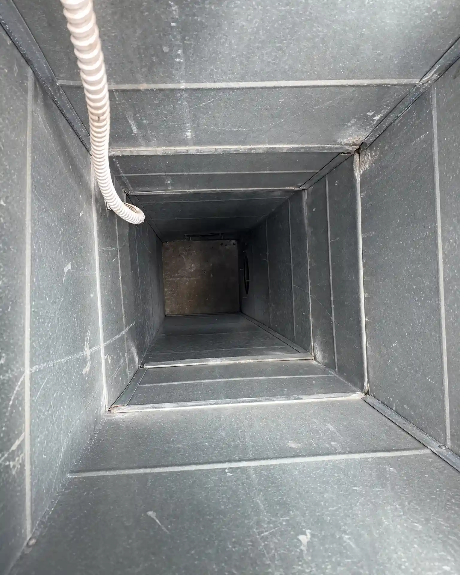 Bare-metal industrial ductwork in the same Ohio plant after Service-Tech Corporation deep cleaning
